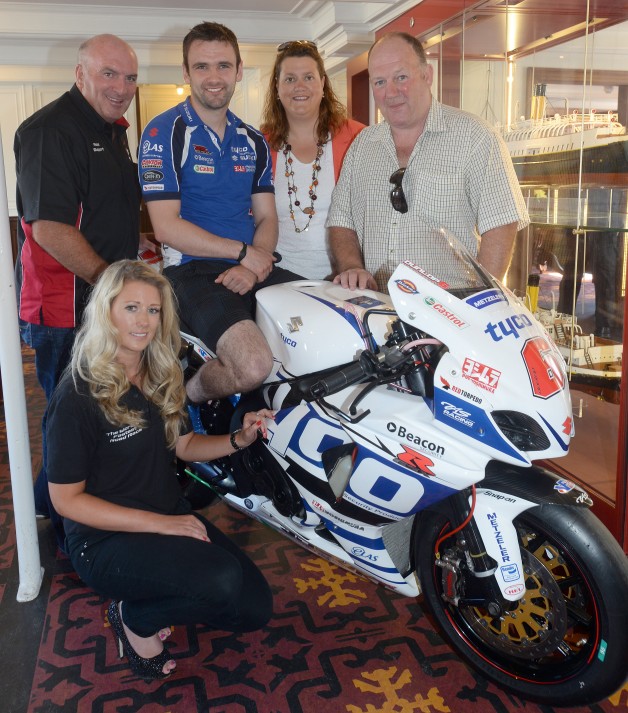 Tyco Suzuki’s William Dunlop is confident he will be fully fit and able to make amends for his premature exit at the Isle of Man TT with a strong performance at the Metzeler Ulster Grand Prix this August.  Pictured is William with Gerard and Siobhan Rice of Around a Pound, sponsors of the Superstock race, Noel Johnston, UGP Clerk of the Course and UGP gird girl Sorrel Flack at the launch of the 2014 Metzeler Ulster Grand Prix on board the SS Nomadic earlier this month. 
