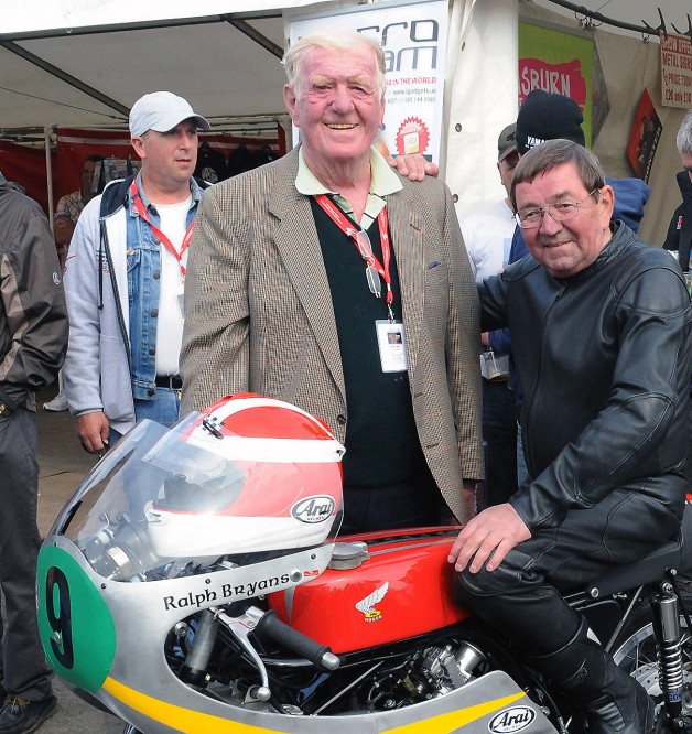 1965 World Champion rider Ralph Bryans, who died on Wednesday 6th August, is pictured in August 2012 prior to taking part in a Parade Lap of the famous Dundrod circuit, one of several events celebrating 90 years of the Ulster Grand Prix.  Included is Jim Lilley from Ballygowan, owner of the bike which Ralph rode in the 1960s.